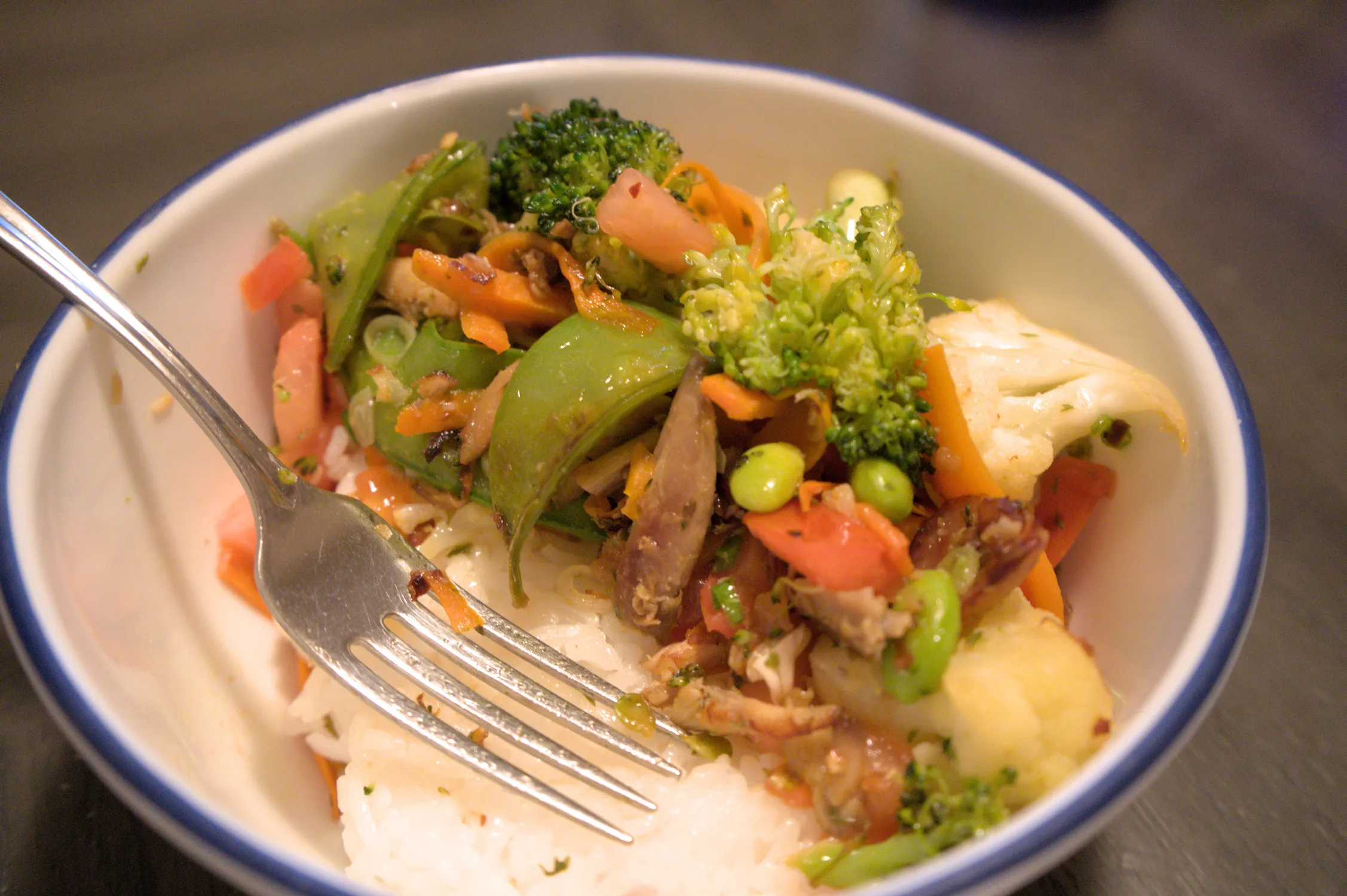 Stir fry in a bowl over rice