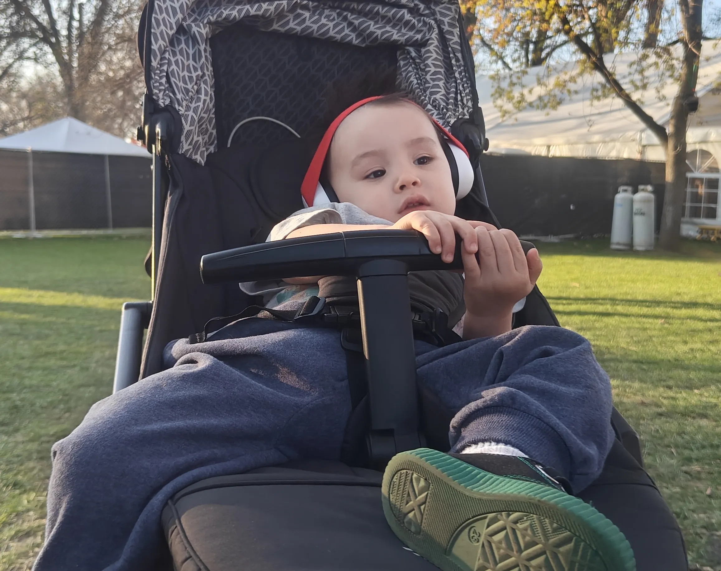 a toddler lounging in a stroller