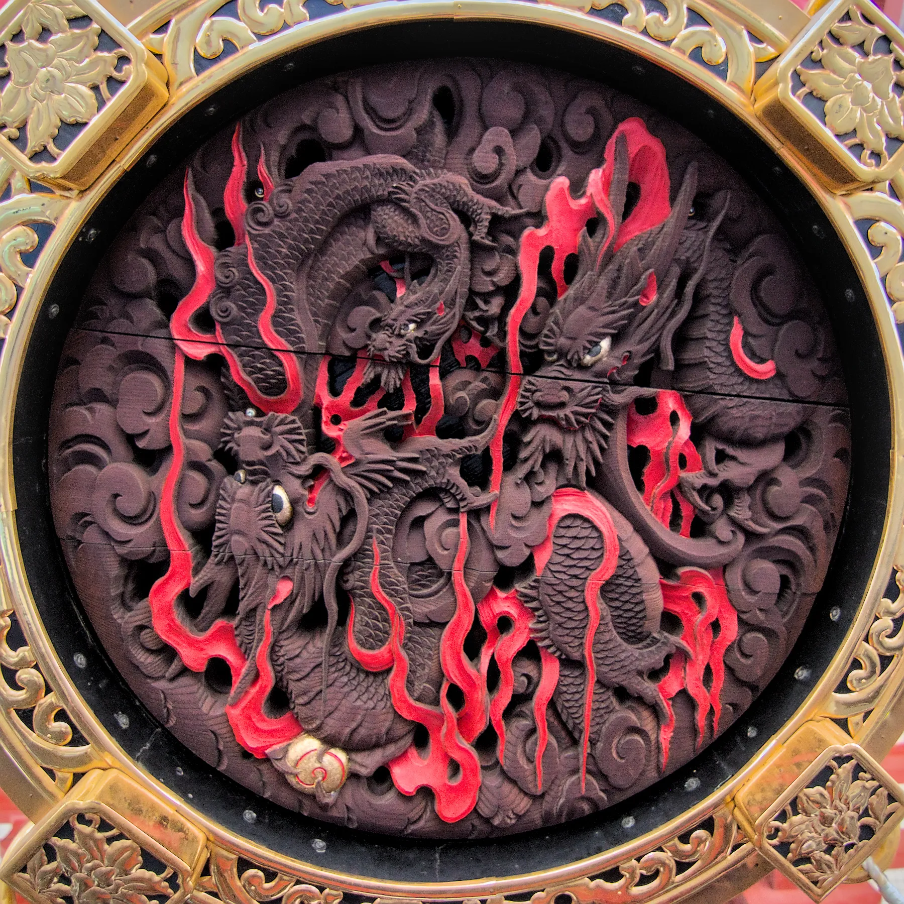 Dragon carving framed by ornate gold trim at Asakusa Temple