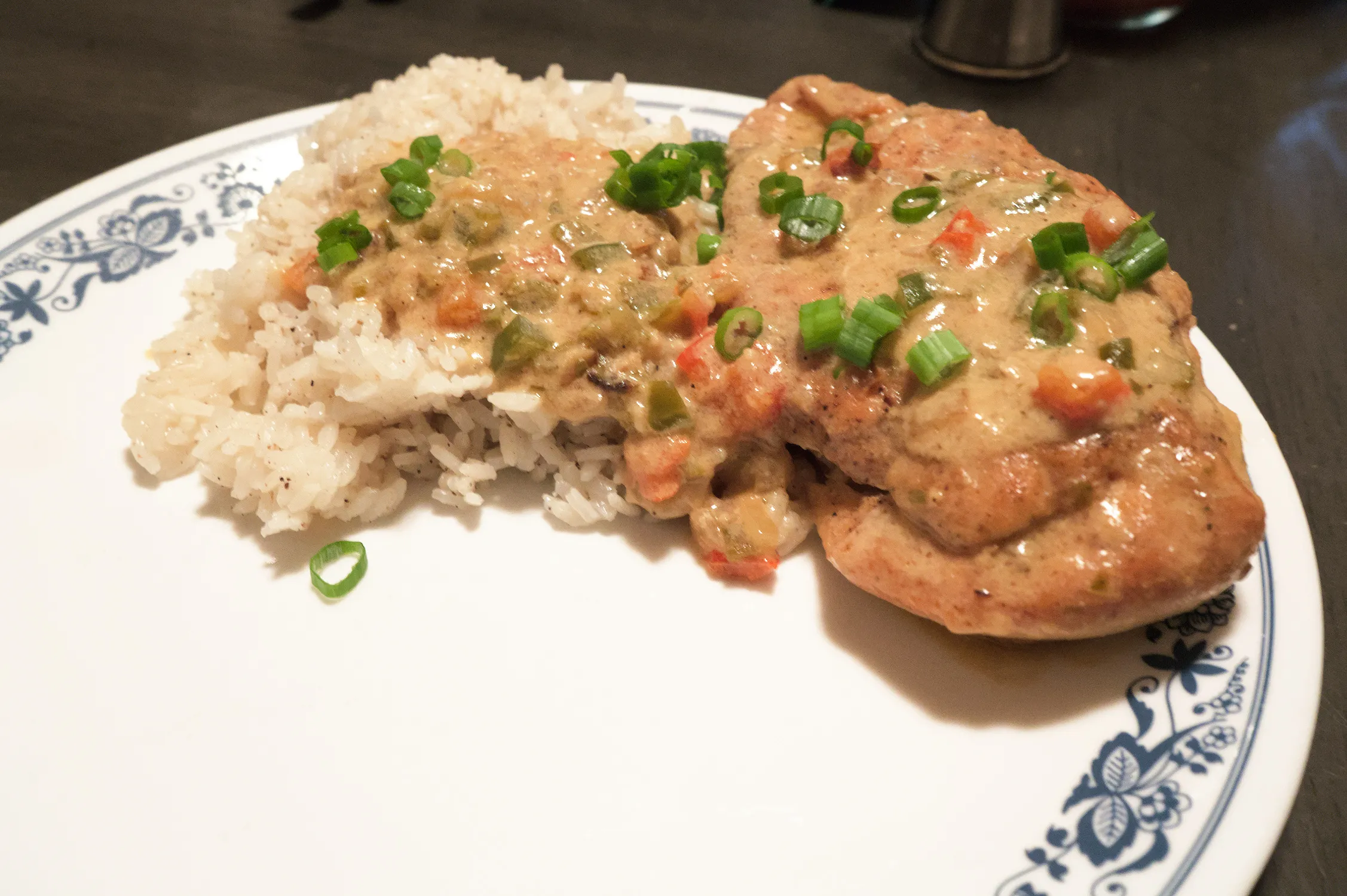 Chicken tarragon with rice on a large white plate