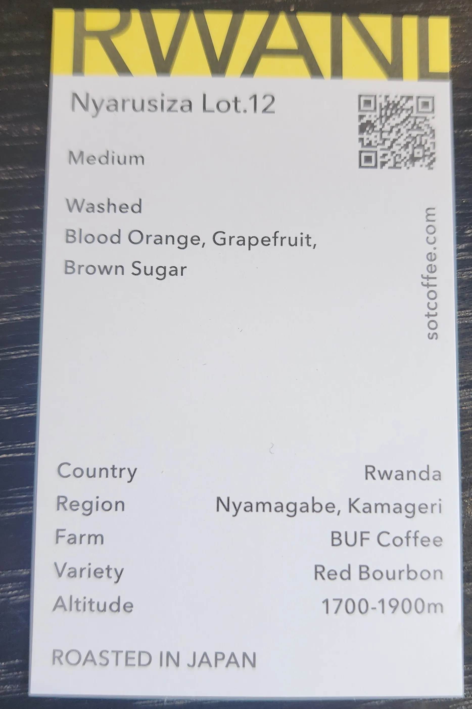 A small card describing the variety and source of a cup of coffee