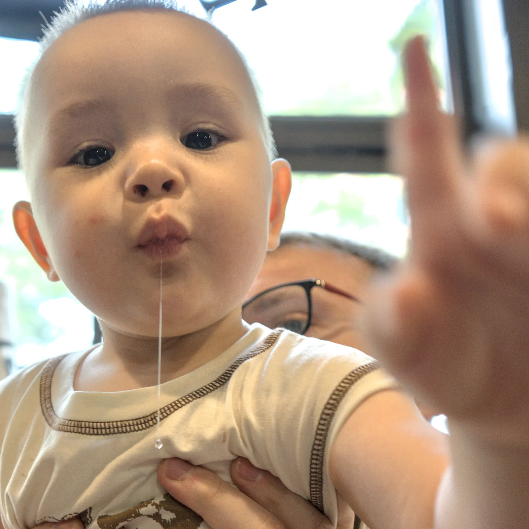 A boy with his finger up, square aspect ratio