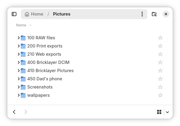 Screenshot of a file manager window showing a “Pictures” directory. The folders are listed in numerical order: “100 RAW files,” “200 Print exports,” “210 Web exports,” “400 Bricklayer DCIM,” “410 Bricklayer Pictures,” “450 Dad’s phone,” “Screenshots,” and “wallpapers.”